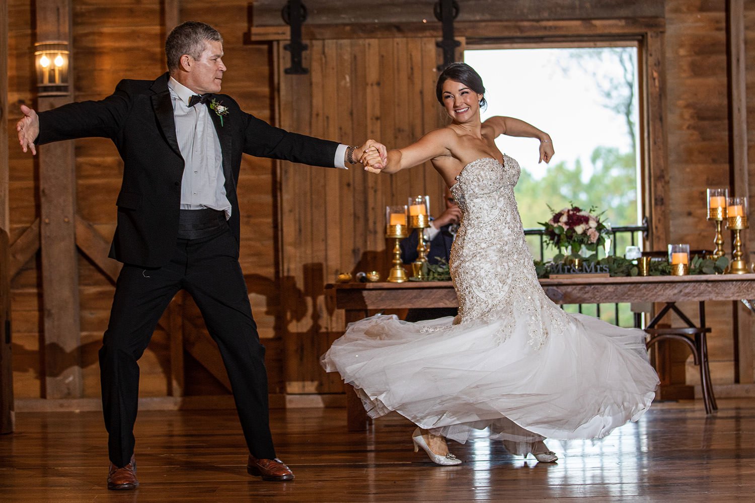 a father-of-the-bride sharing a wedding dance with his daughter to one of our father-daughter dance songs on the list