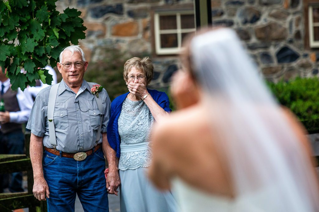 A bride doing a first look with her grandparents at a wedding.