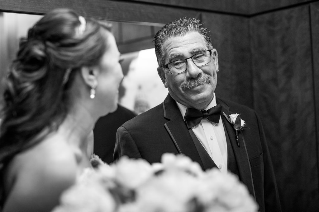 a loving father looking at his daughter on her wedding day.