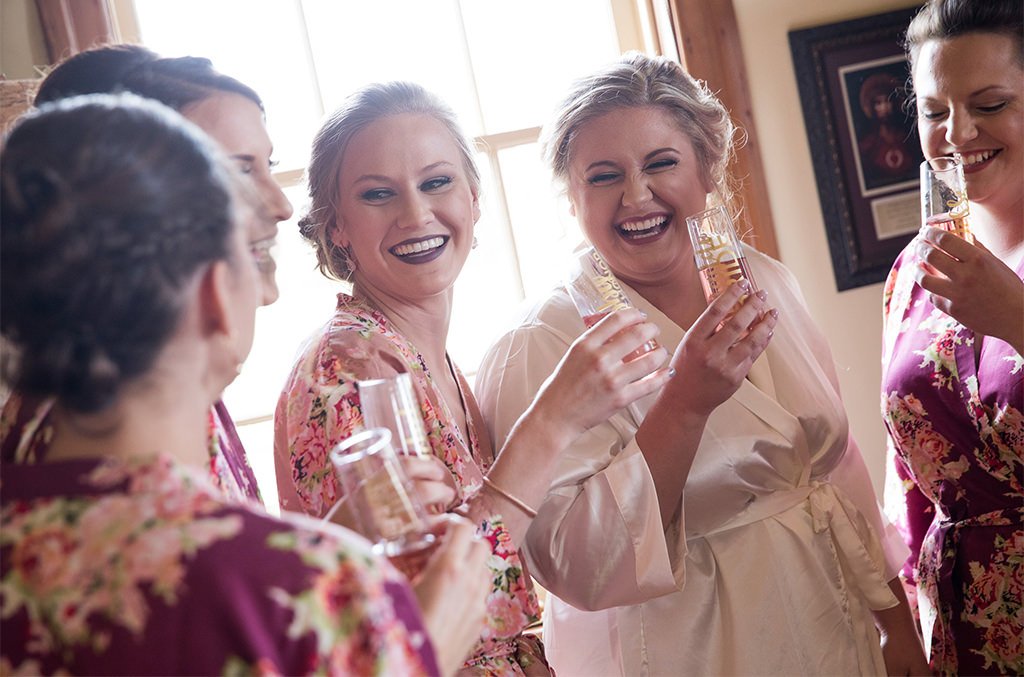 A bride and bridesmaids talking about their wedding day emergency kit