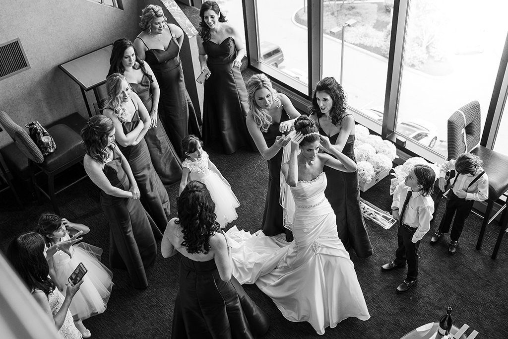 A bride getting dressed after putting together her wedding day emergency kit