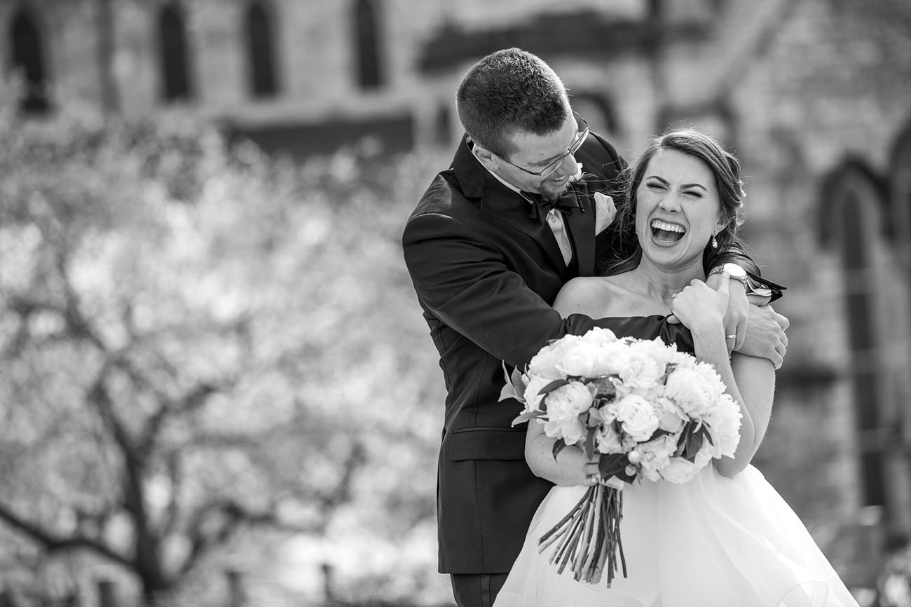 A bride laughing after finding out what the groom said during the he said she said bridal shower game