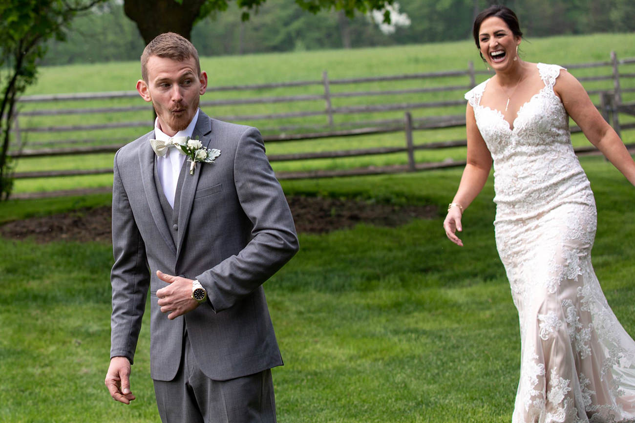 A bride sneaking up on the groom to be funny