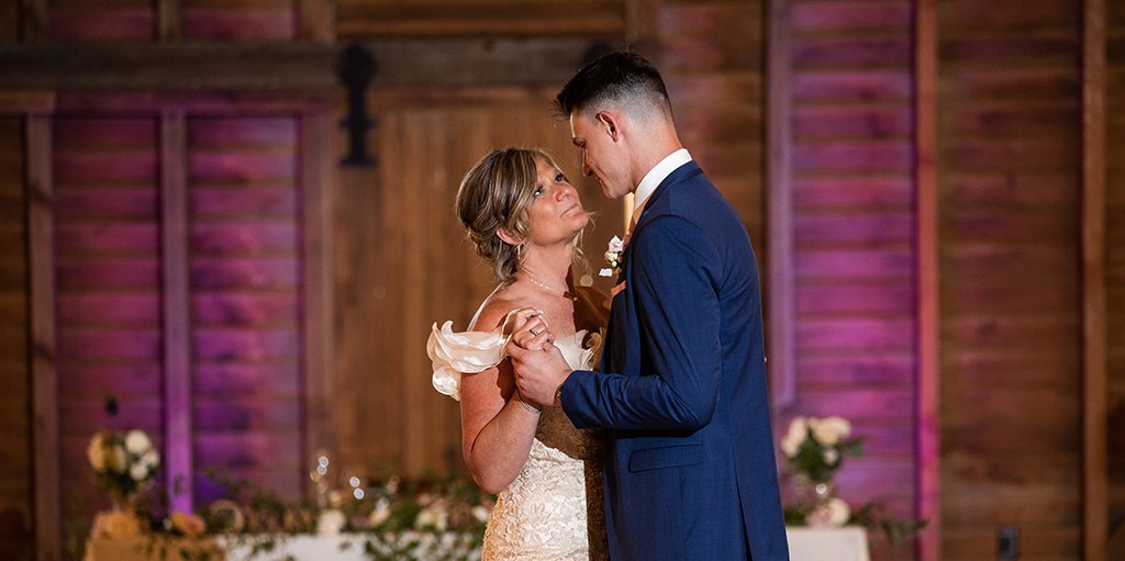 A mother and son dancing together at the wedding reception. They are dancing to their favorite two songs.