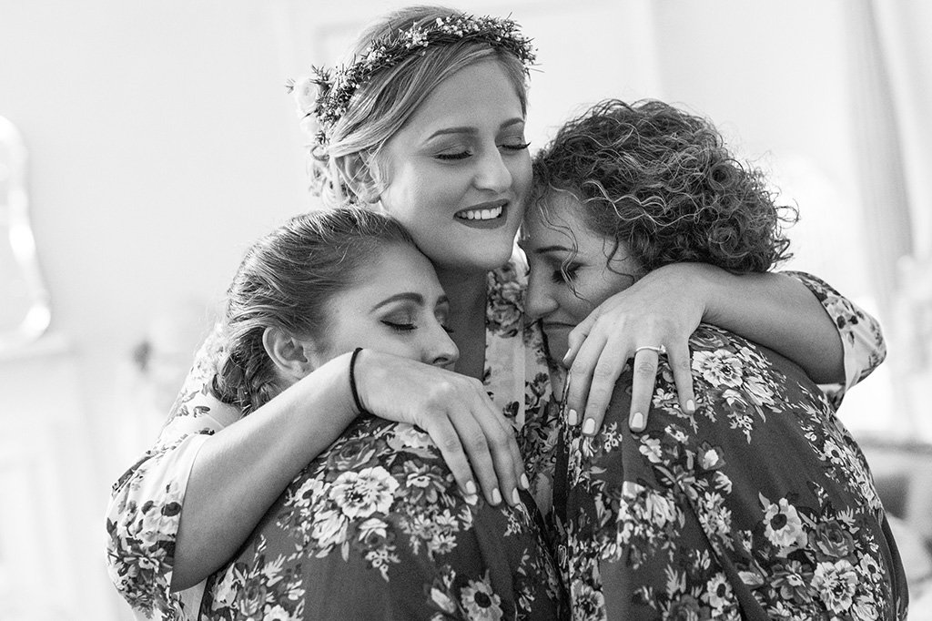 A bride hugging bridesmaids after playing bridal shower games