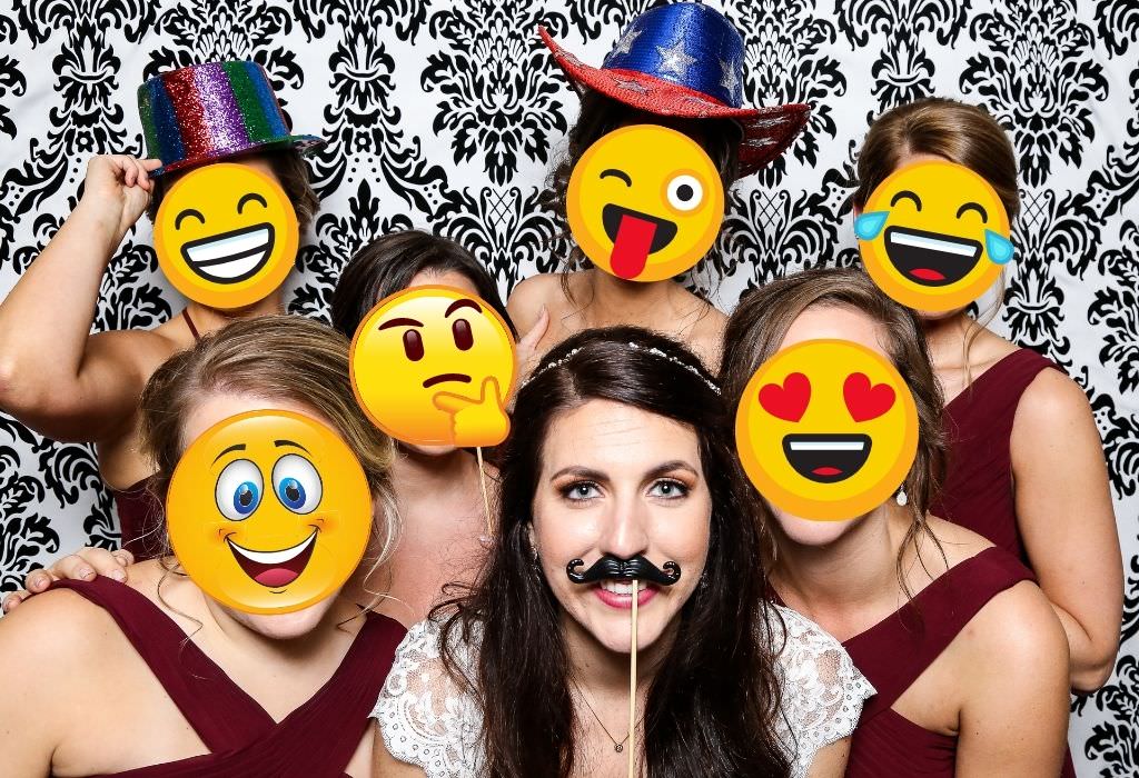 A funny photo of a bride and her bridal party wearing emoji masks. This is for the emoji bridal shower Pictionary game.