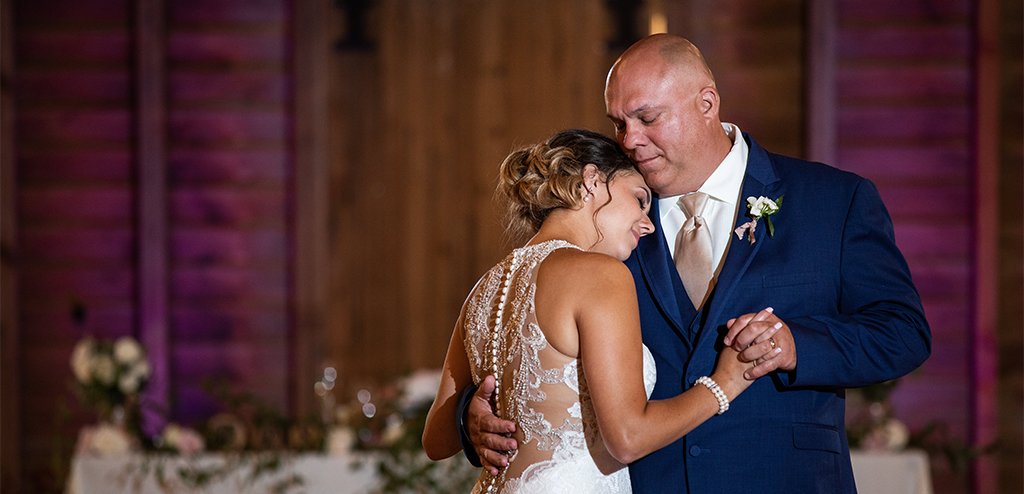 An emotional bride and father of the bride doing a dance together at the wedding reception. They are dancing to their favorite song.