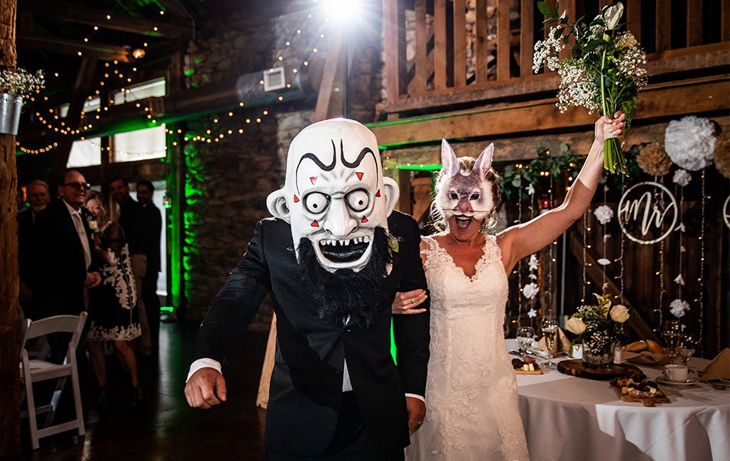 a photo of a bride and groom wearing a heavy metal mask for their wedding entrance. This is for the post about heavy metal and hard rock songs.