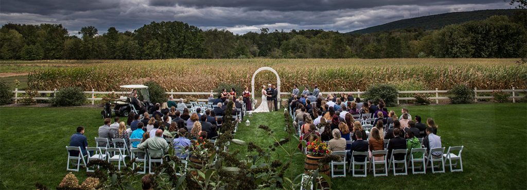 a backyard wedding near a cornfield. This is an overhead view of the ceremony taking place.