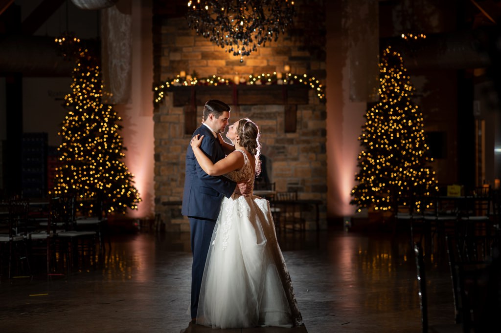 A bride and groom doing a last dance of the night at their wedding reception. They are dancing to their favorite song.