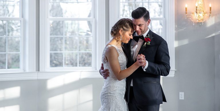 A bride and groom sharing a first dance at their wedding reception. They are dancing to Everything by Michael Buble.