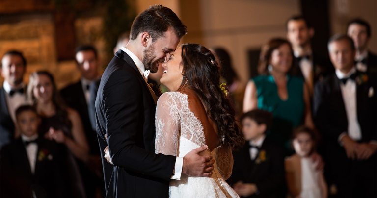 A bride and groom dancing to their favorite songs for the first dance at the wedding reception.