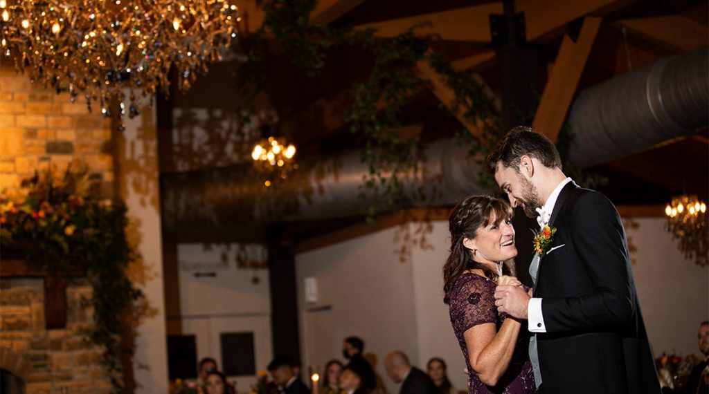A mother dnacing with her son at a wedding reception. they are dancing to Michael buble.