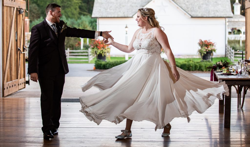 A bride doing a spin during her wedding first dance.