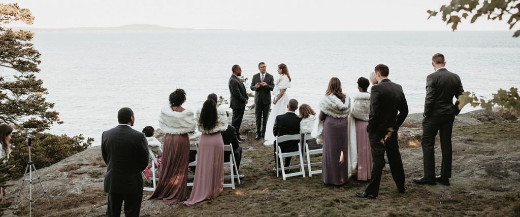 A bride and groom getting married in a micro wedding along the coastline of the atlantic ocean
