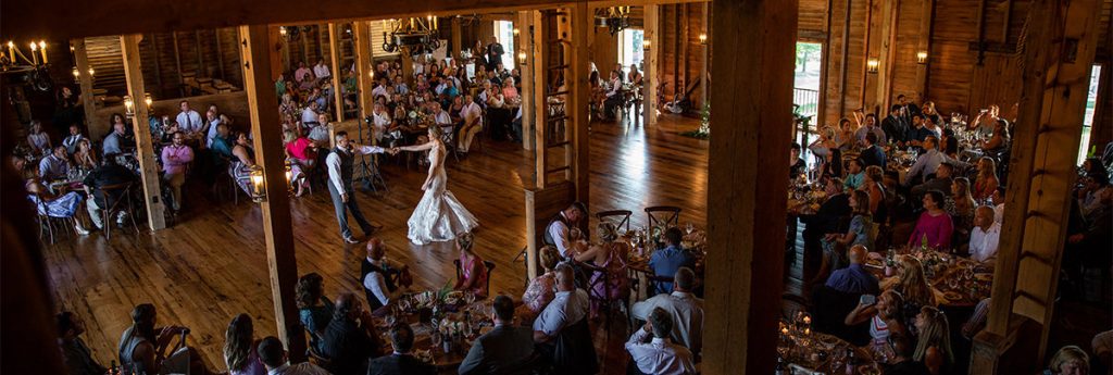 A bride and groom dancing on the dance floor at their reception. hey are doing their first dance to The Beatles.