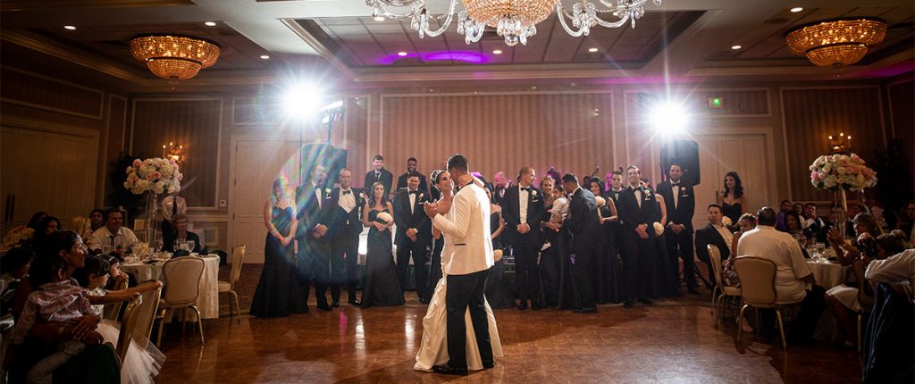 a bride and groom dancing their first dance a wedding reception. they are dancing to The Beatles.