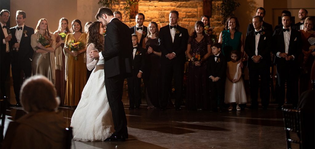A couple dancing their first dance at their wedding. Tey are dancing to one of their favorite songs.