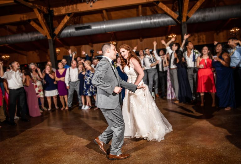 a photo of a brother dancing with his sister at a wedding. They are dancing to the best songs.