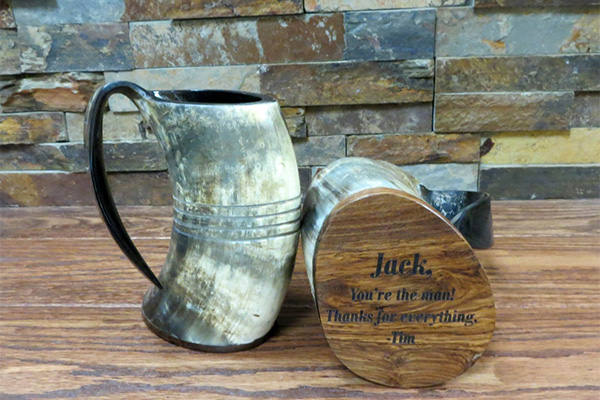 a buffaloe horn mug with engraving on bottom