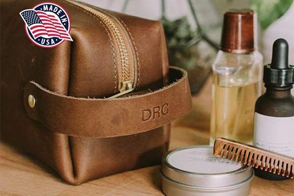 A personalized leather dopp kit sitting on a table