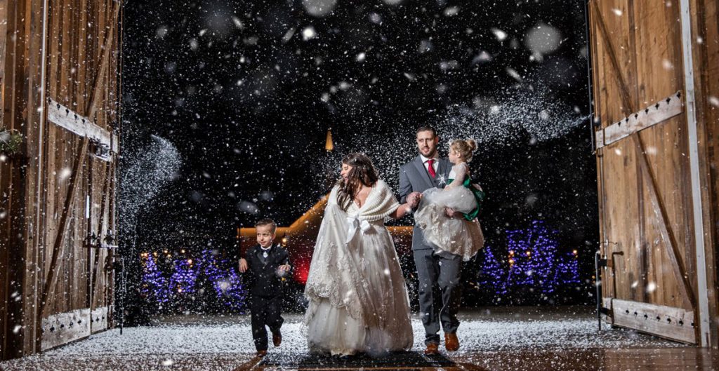 A bride and groom doing a wedding reception exit or entrance with fake snow