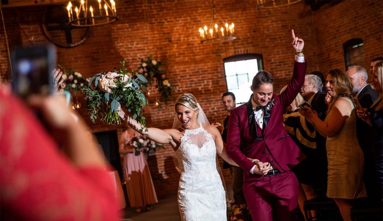 Two brides walking back down the aisle after being married. They are walking out to a modern instrumental song.