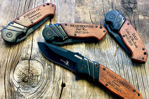 a pocket knife that is engraved with a name and date
