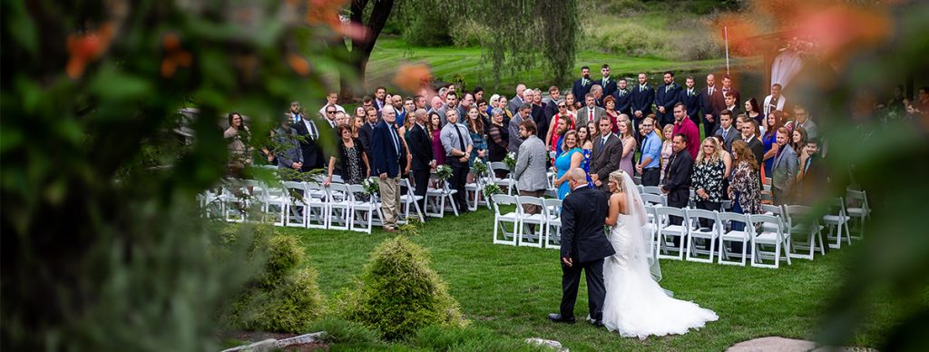 A bride and her father walking in to a good song for the wedding ceremony processional
