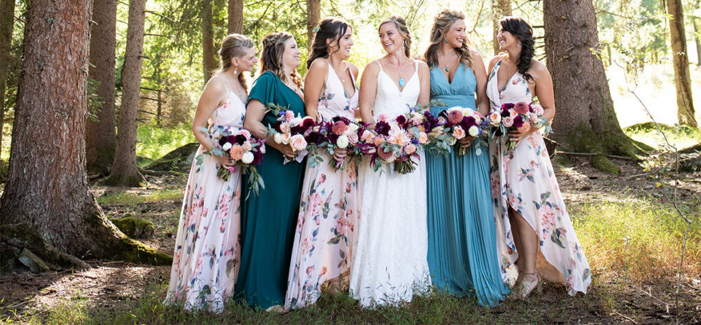 Bridesmaids posing in the trees looking at each other
