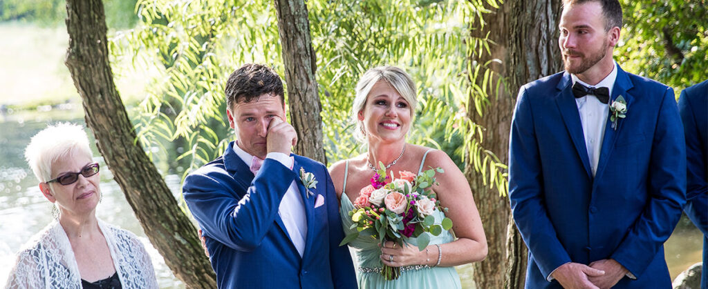 A groom crying as he watched the bride walk down the aisle at a wedding ceremony.
