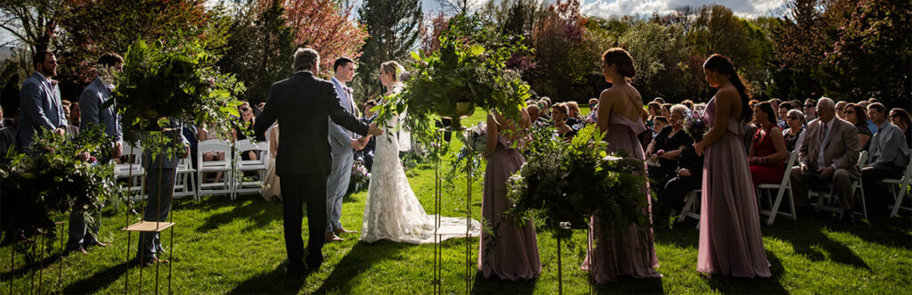 A beautiful wedding ceremony with the sun setting behind.