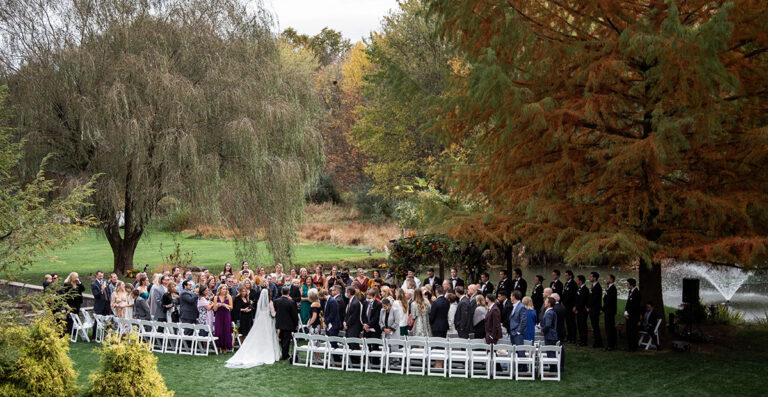 A bride walking down the aisle from behind with her father