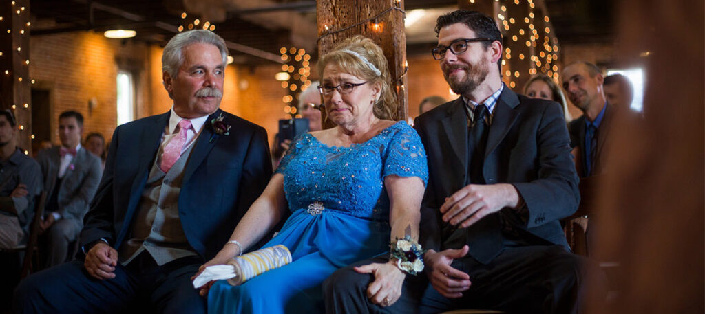 A bride's mom and dad watching the wedding ceremony.