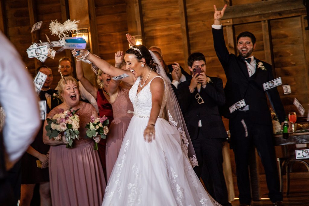 A bride making it rain with money during the grand entrance at the wedding reception.