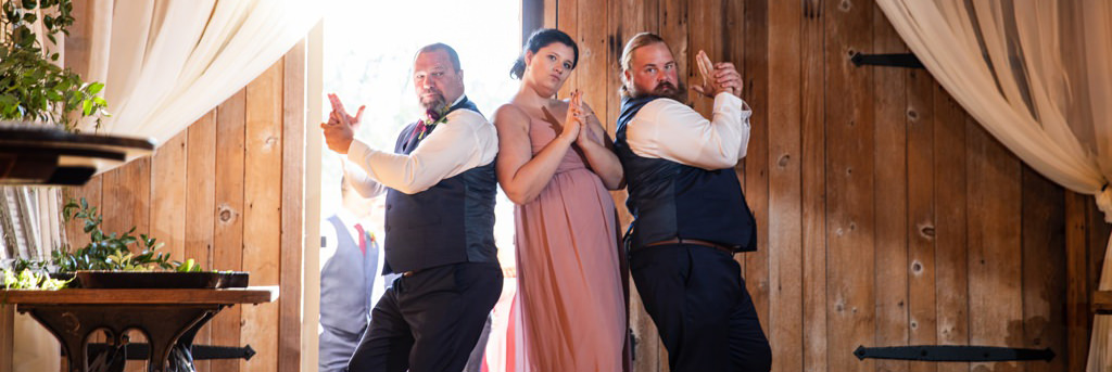 A wedding party doing the Charlie's Angles pose