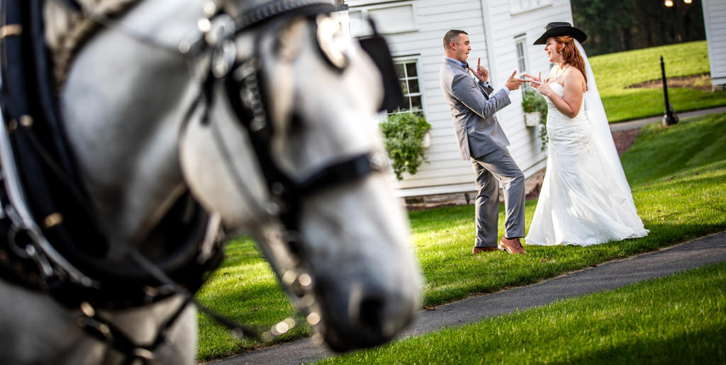 A bride and groom with cowboy hats. This is for the best country songs for your wedding first dance.