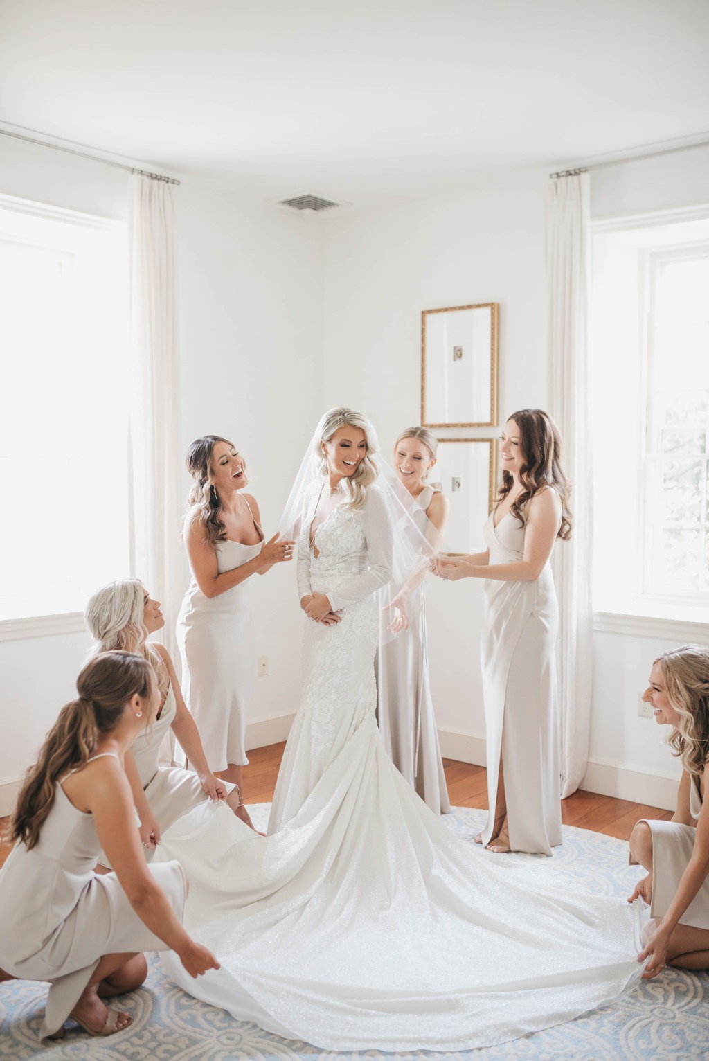 A bride getting into her wedding dress in the bridal suite at The Farm at Eagles Ridge.