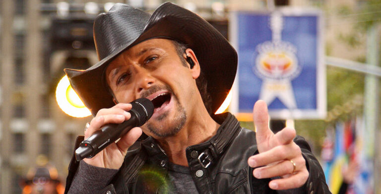 A photo of tim mcgraw singing a wedding love song while wearing a cowboy hat. This is for the article called tim mcgraw wedding love songs.