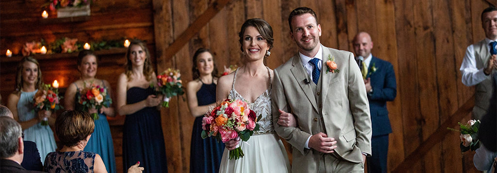 A happy couple walking down the aisle at the end of their wedding ceremony.