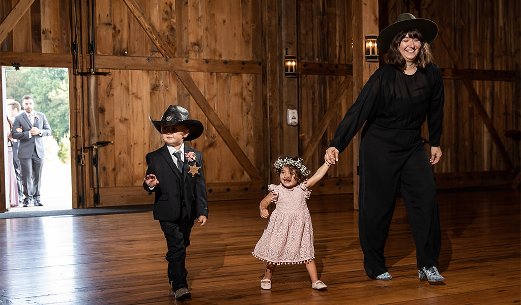 A ring bearer and flower girl entering the reception. This is for the article called best bridal party wedding reception entrance songs