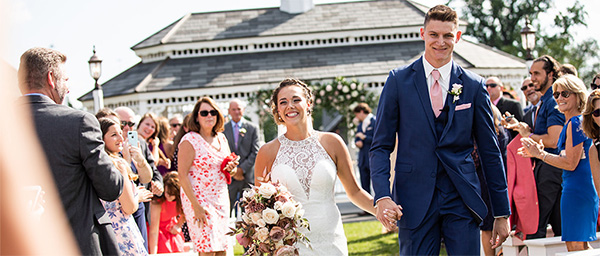 A bride and groom walking down the aisle after their wedding ceremony. This is the cover photo for the article called best wedding ceremony recessional songs