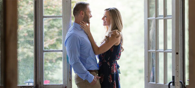 a girl touching a guy on the face before the kiss. This is the cover photo for the article love songs for her.