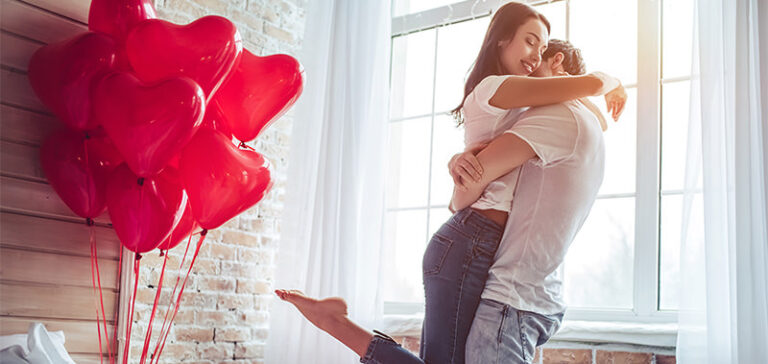 A man lifting a woman and giving her a hug. This is the cover photo for the article called Love Songs For Him