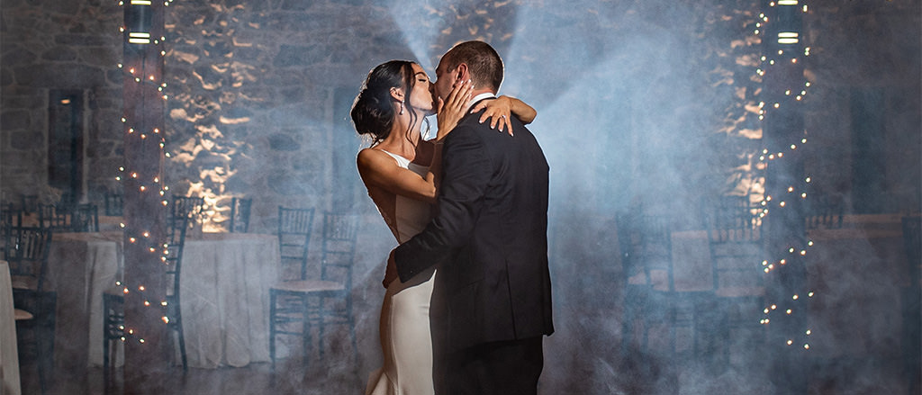 A man and woman kissing on the dance floor while listening to romantic music. This is for the article called Love Songs for Him.