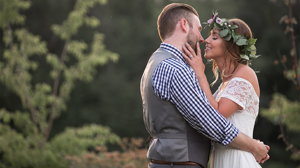 A woman kissing a man with her hand on his cheek. This is for the article called Love Songs for Him.