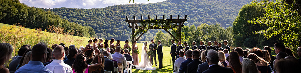A bride and groom getting married at an outdoor wedding.