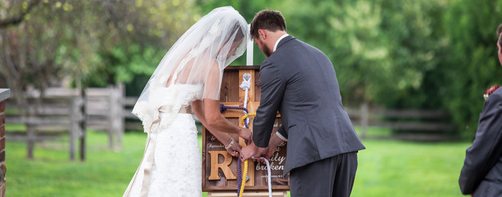 A bride and groom doing a rope braiding ceremony