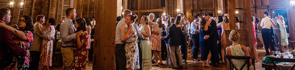 Wedding guests doing the anniversary dance at a wedding reception. This is for the article called best songs for the anniversary dance at your wedding.