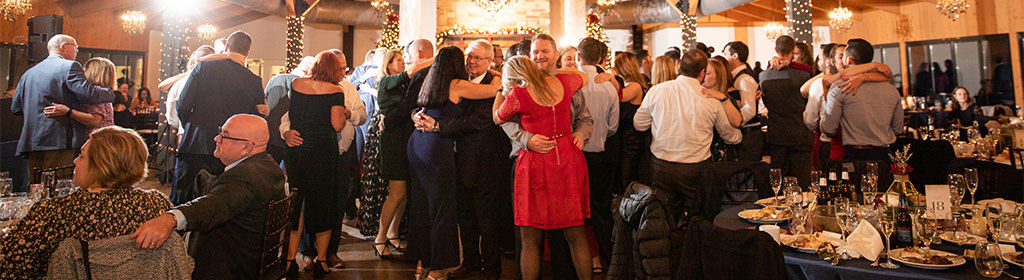 Married couples dancing during the anniversary dance at a wedding reception.